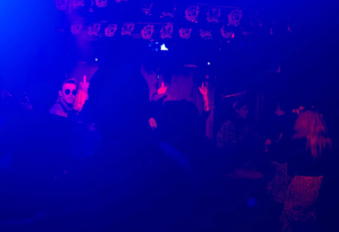 Dancers in blue and pink light at a party