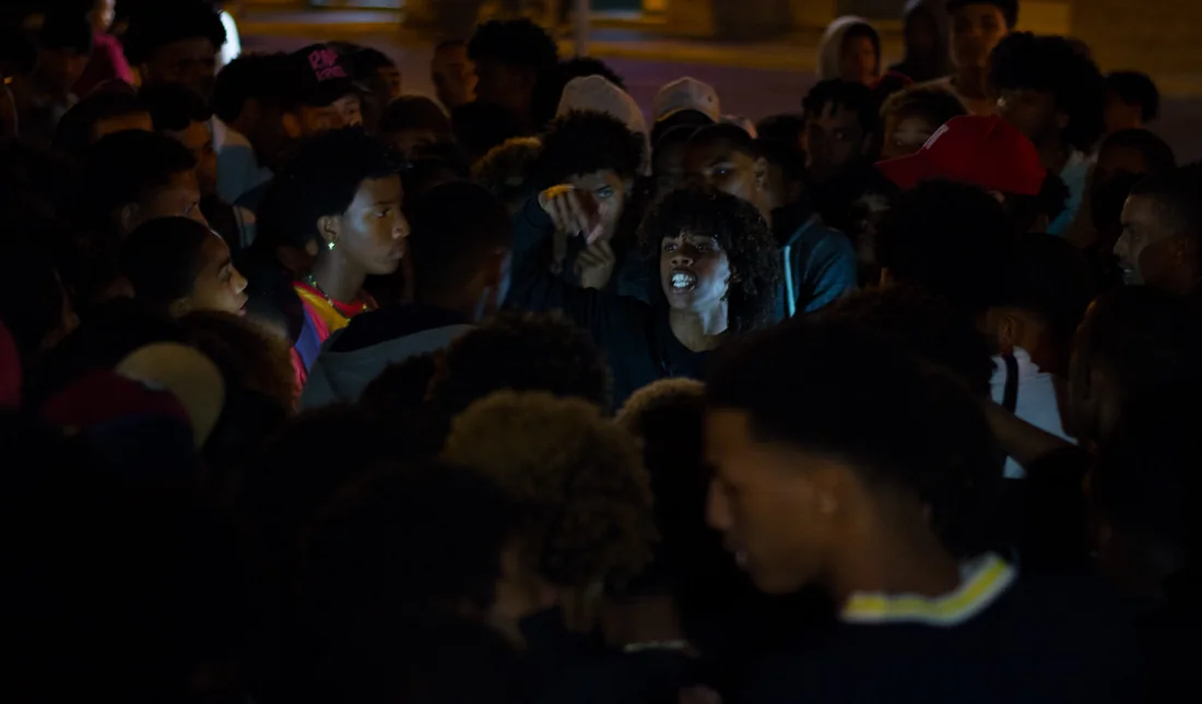 Rapper in a crowd at night, pointing